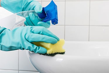 cleaning a bathroom by house cleaning services in Mount Prospect